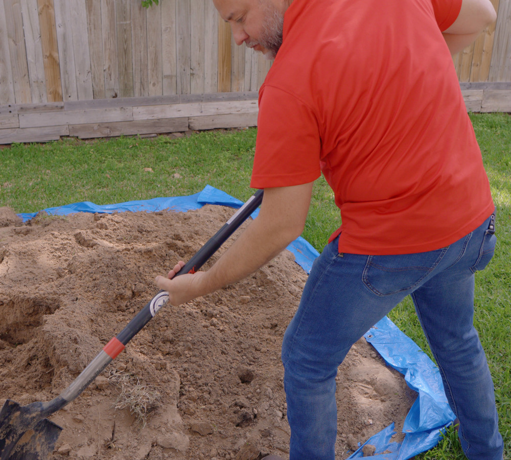 Digging to expose a buried sewer line