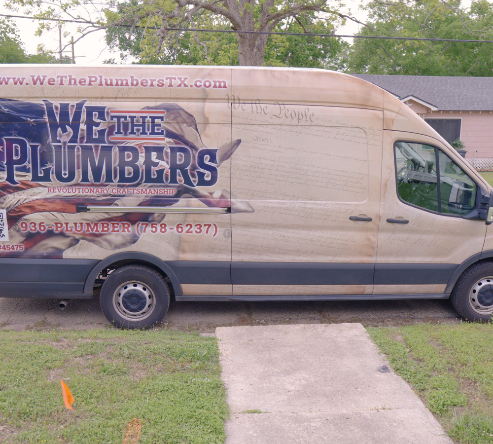 The We The Plumbers van, wrapped with the company name, phone number and master plumber license number