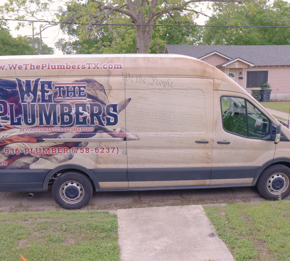 The We The Plumbers van parked on a residential street